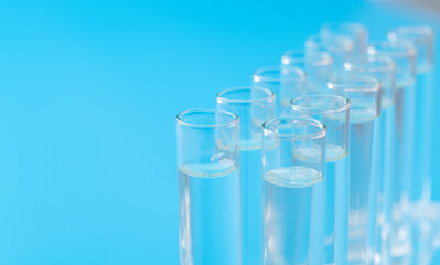 Test tubes with liquid on blue background