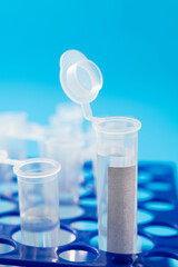 Test tubes with liquid on blue background