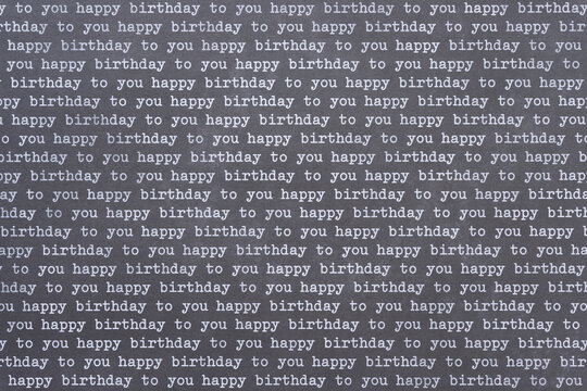 scrapbook paper background with the words: happy birthday to you repeated over and again