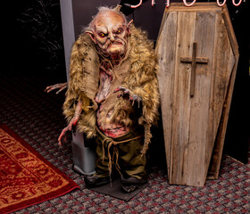 Small Zombie Next To Wooden Coffin