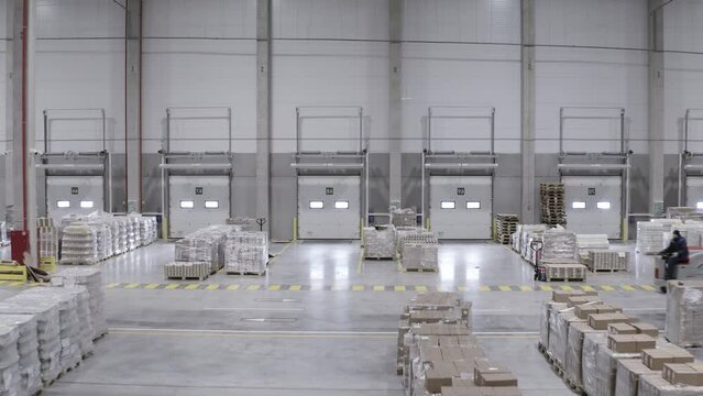warehouse operation. the cargo is lying on the floor of a large clean warehouse. the equipment works.