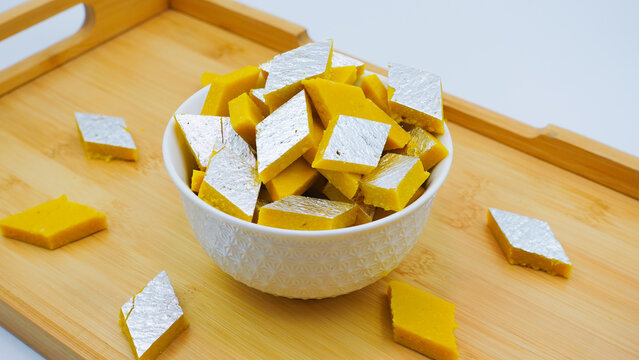 Kaju Katli is a traditional Indian Diamond shaped sweet or Mithai made using cashew paste, sugar, and mava or Khoya. Almond Sweet burfi or barfee. Popular festive food and sweet from India.