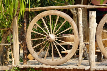 Fototapeta na wymiar old wagon wheel in the park