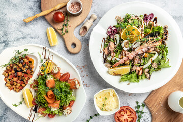 Set of seafood dishes shrimps salad fresh salmon rolls salad with cheese and vegetables. Asian menu. Delicious breakfast or snack, Clean eating, dieting, vegan food concept. top view