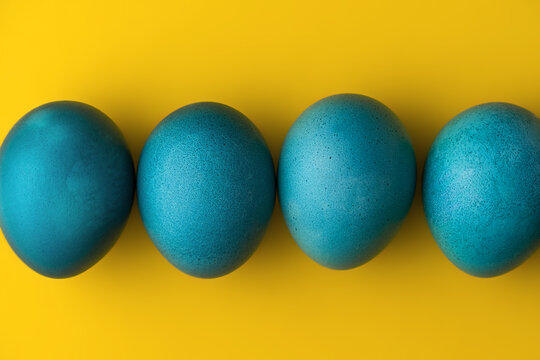 Blue easter eggs on yellow background. Colors of the flag of Ukraine