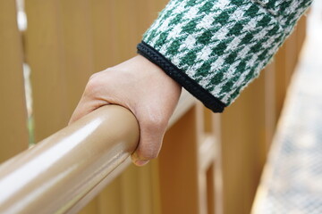 human hand touch Wooden railings at tourist attractions are vulnerable to Covid-19