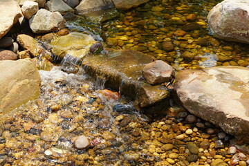 Landscaping by allowing water to flow through by using rocks as a ground and blocking the flow of water in the desired direction.