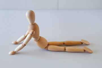 Wooden doll as a model for exercising in a healthy life