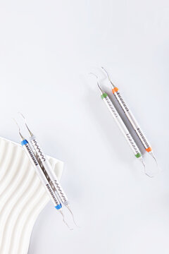 Dental instruments on a bright podium.The work of an orthodontist.Modern dentistry.Vertical photo.Flat lay.Top view.Copy space.