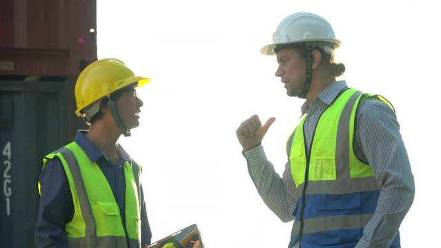 diversity worker foreman and secretary using document file meeting with worker to checking  control loading Containers box at warehouse logistic in Cargo freight ship for import export in harbor.