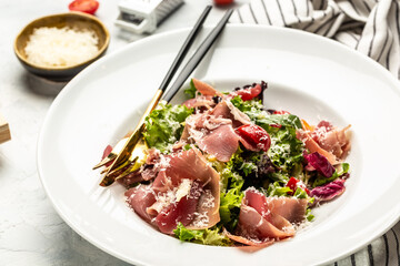 Salad with Prosciutto, ham and grapefruit jamon, salad mix, grapefruit, cherry tomatoes, parmesan cheese. Healthy food, keto diet, diet lunch concept