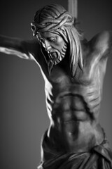 Obraz na płótnie Canvas Religion theme - Jesus Christ. Cruciefied Jesus figure isolated on rustic dark background.