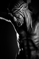 Religion theme - Jesus Christ. Cruciefied Jesus figure isolated on rustic dark background.