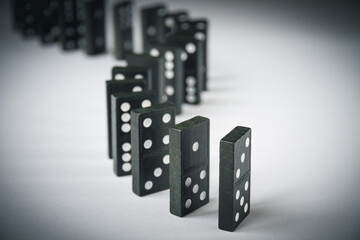 Black dominoes chain on white table background