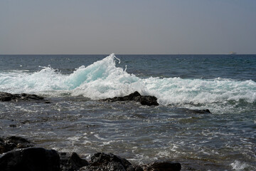 ocean wave breaking on the rocks near the shore
