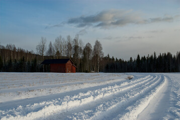 Fototapeta na wymiar A lonely shack on a snowy day