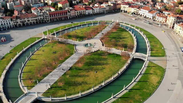 Aerial view of Padua in northern Italy. Drone view of Prato della Valle. A canal in the shape of an ellipse around the central part of the square. Bridges over the canal and a double row of statues