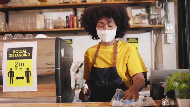 African American barista woman is stressed because of The effects of the coronavirus pandemic resulting in business losses.the impact of a small self-employed business.