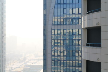 Skyscrapers with reflective windows in foggy sunlight