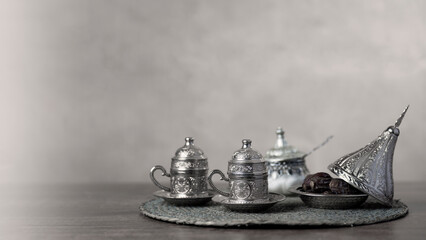 Fototapeta na wymiar Silver coffee or tea cup and sugar jars with Dates