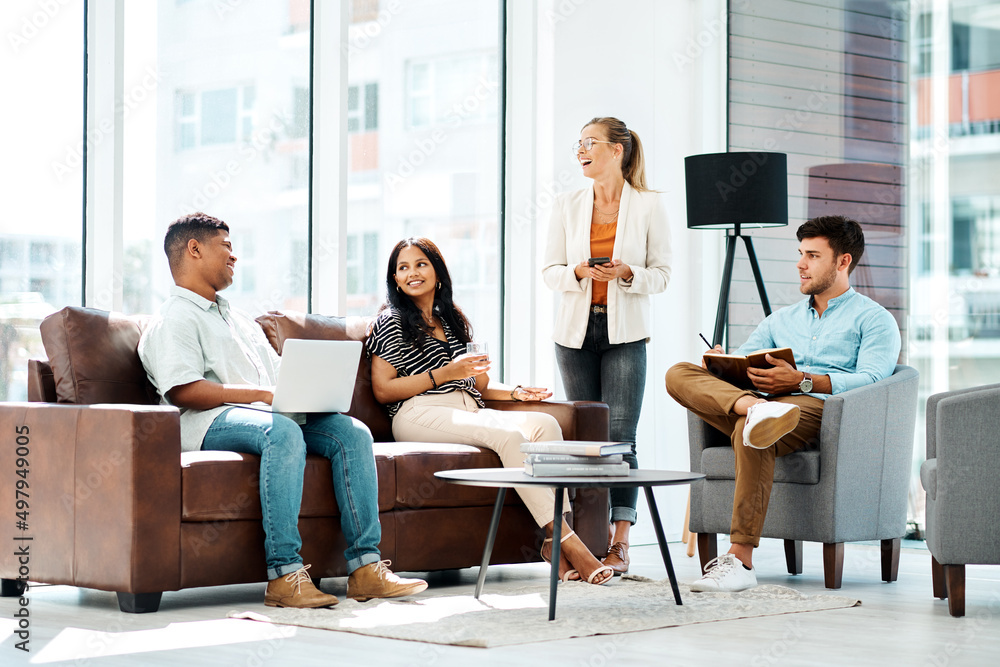 Poster inspired to keep on producing greatness. shot of a group of businesspeople having a discussion in an