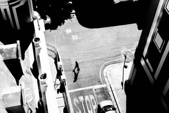 black and white image from a building of pedestrians