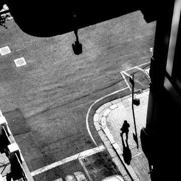 black and white image from a building of pedestrians
