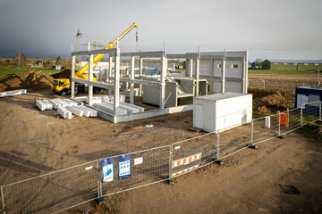 Fototapeta premium the basic structure of an industrial building is erected on a construction site