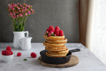Pancakes decorated with raspberries and flowers