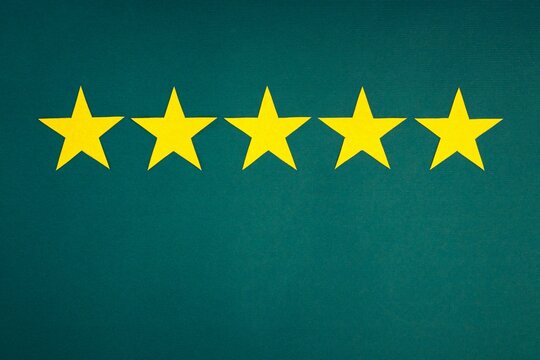 Rating in the form of yellow stars on a green background. The concept of service quality assessment.