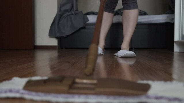 Woman Mopping Wooden Floor With A Damp Cloth On A Mop, Home Cleaning, Service