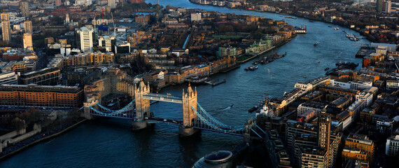 Sunset panorama of London with the most iconic symbol of London, Tower Bridge illuminated by the...