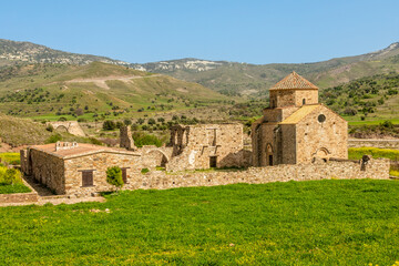 Fototapeta na wymiar Ruins of Panagia tou Sinti ortodox Monastery with temple in the center, Troodos, Cyprus
