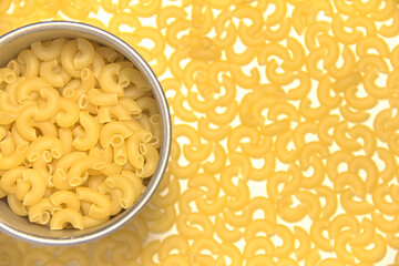 Yellow pasta in a metal mug. Top view.