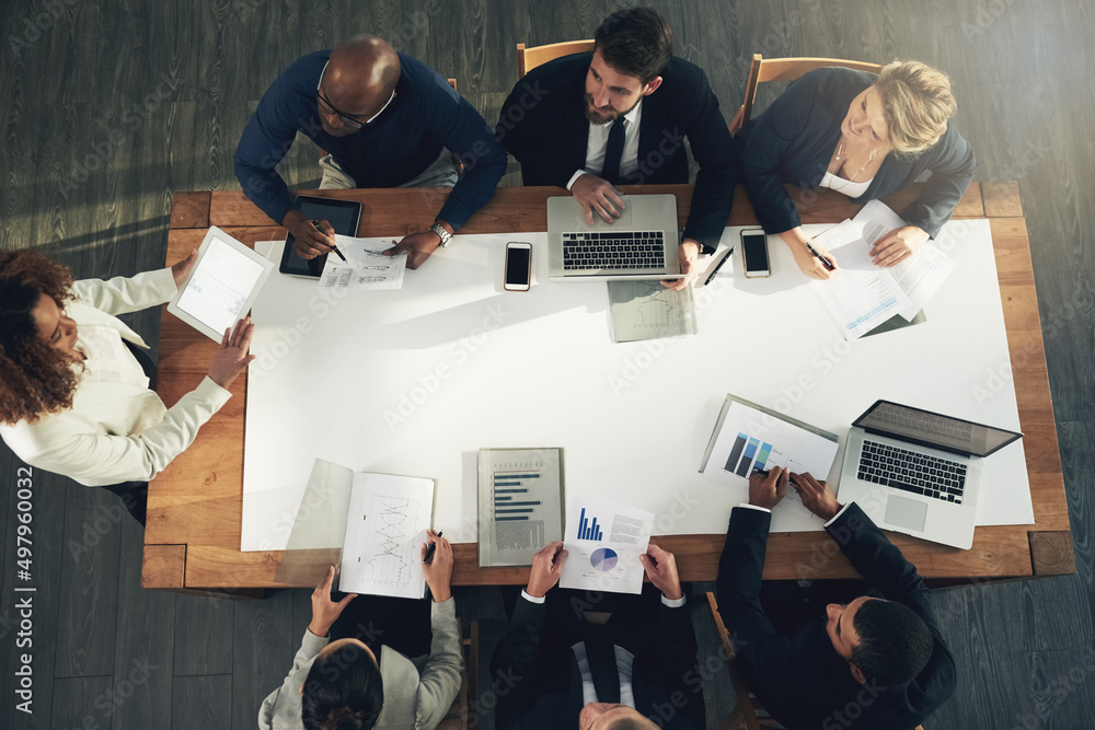 Aufkleber discussing innovative ideas. high angle shot of a team of businesspeople working around a table in t