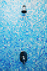 A shower on the blue wall