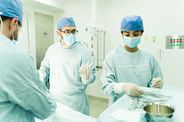 Surgeons and nurse at the operating room