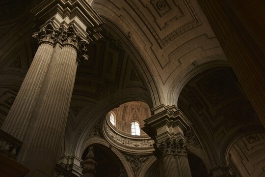 Elegantly coffered and decorated main dome above the transept of Ja&eacute;n Cathedral, embedded in an ensemble of columns and vaults expessing pure Spanish Renaissance style, Ja&eacute;n, Spain