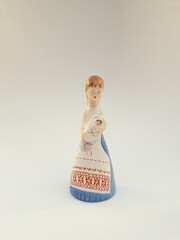 Vintage porcelain figurine - young mother in traditional folk art costume with a baby