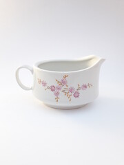 Vintage porcelain saucer, pitcher with pink flower pattern, isolated