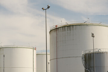 Close-up of white industrial fuel plant on a sunny day