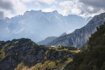 Mountain panorama with rocks, green forest and a country house in the middle, Zugspitze, Germany...