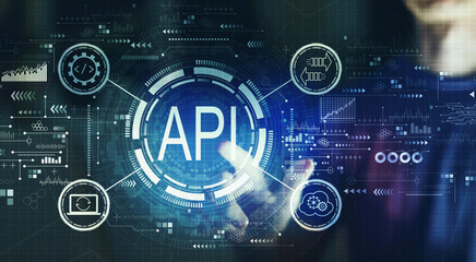 API - application programming interface concept with young man touching a digital screen at night