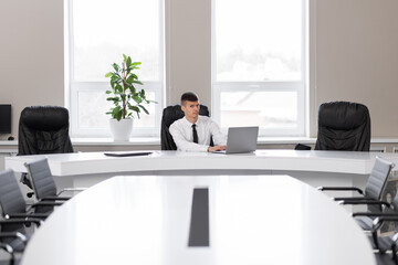 attractive young man in the office in a conference room alone