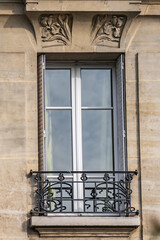 Obraz premium Traditional French house: balconies and windows. Paris, France.