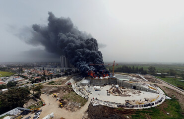Acre, Israel - April 8 2022: Bahai construction site caught fire and huge smoke pillar covering residential neighborhood 