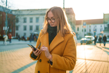 Close up of woman hands using a smartphone at street