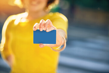 I prefer to pay with plastic. Shot of an unrecognizable young woman holding a credit card.