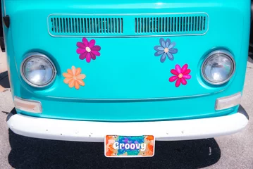 Deurstickers front of turquoise van with colorful daisy flowers © Tamela