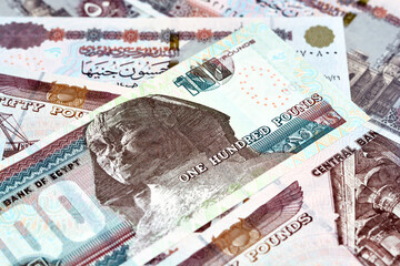 Pile of Egyptian money banknotes of 100 LE, 50 LE, selective focus of a stack of one hundred...